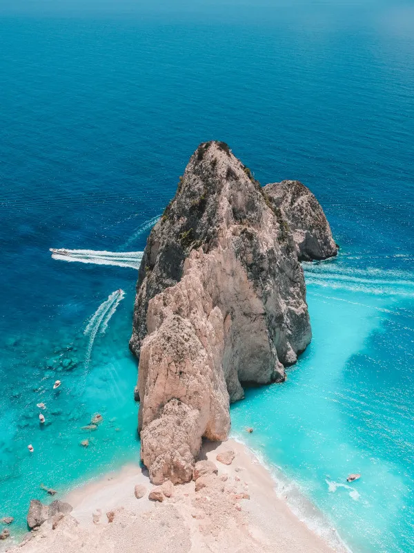 Brown rock formation on body of water